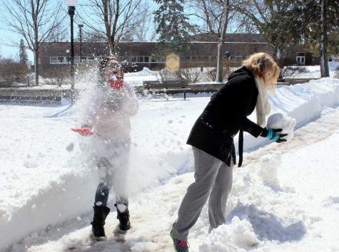WSC students Alyssa Seamann was hit in the face by a snowball while Dani Isom prepares another snowball for another round.