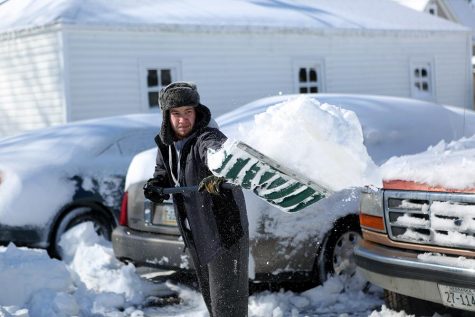 WSC student Jared Guthrie shovels snow out of the way to his car.