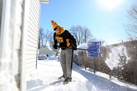 WSC student Nate Lechtenberg shovels snow that Winter Storm Selene blew around the Midwest.