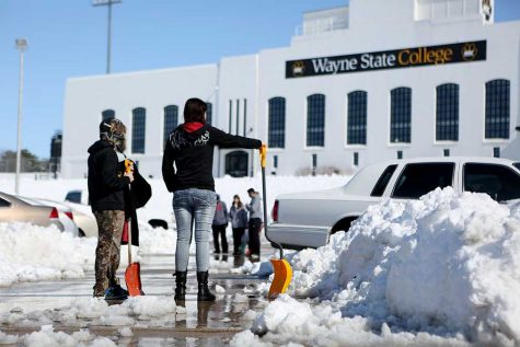 Students work on digging out their cars from the fast melting snow that fell last Wednesday into Thursday.