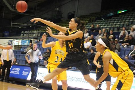 Jordan Spencer takes flight and passes the ball to a teammate in their 71-57 win over Augustana. 