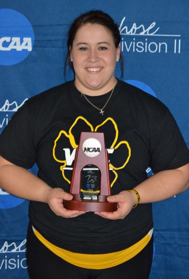 Carly Fehringer poses with a trophy after last season’s National meet. She one day hopes to be a part of the USA National Team.