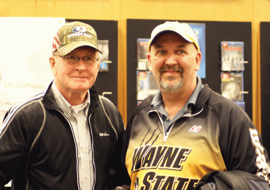 Wayne State wrestling coach Greg Vander Weil poses with former Olympic and Iowa wrestling coach Dan Gable at a book signing in Sioux City.