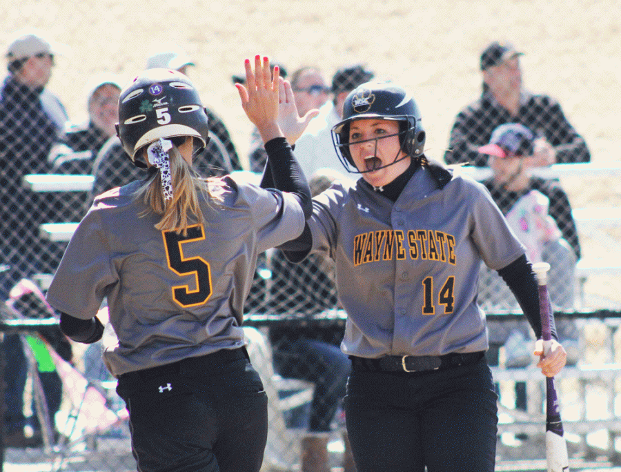 Kaiti Williams high-fives Megan Hagemann after she crossed the plate for a run in a contest earlier this season.