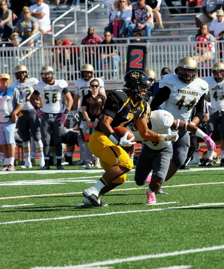 Wide Reciever Marcel Dunson (7) tries to escape a tackle.