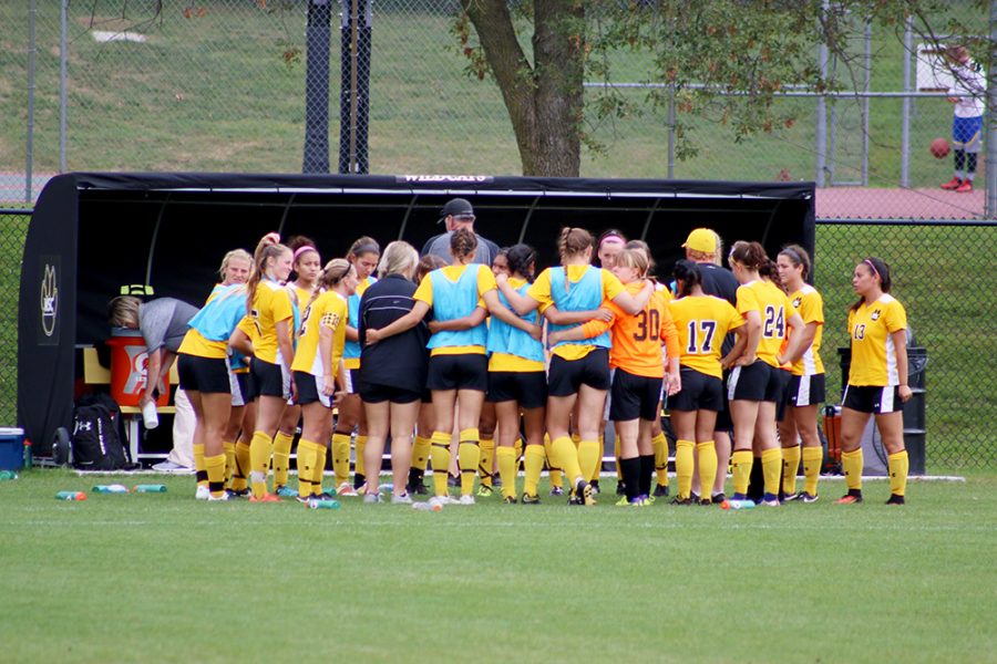 The+WSC+women%E2%80%99s+soccer+team+gathers+together+during+a+time+out+during+Saturday%E2%80%99s+evening+match+against+Northern+State+University.+The+Wildcats+won+the+game+in+double+overtime+after+trailing+2-0+in+the+first+half.+The+home+game+was+also+senior+day+for+the+seniors+on+the+team.