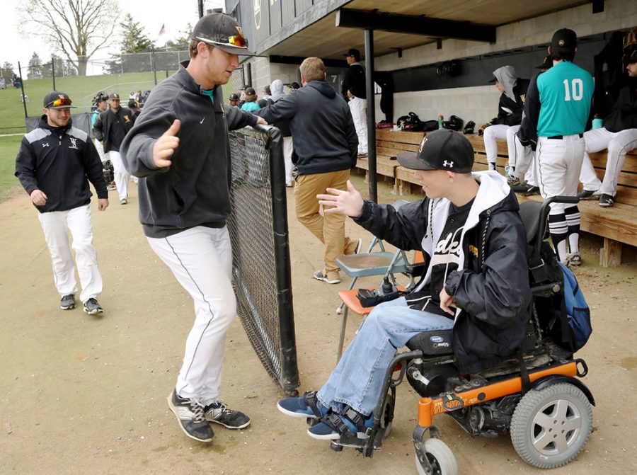 The Wildcats baseball team welcome Jess Gibson into the dugout during Thurdsay’s game against Upper Iowa University. Gibson is part of the Team Impact organization that pairs children with disabilities or who face chronic or life-threatening illnesses with a college athletic team. Gibson chose to be part of WSC’s baseball team, where he participated in a signing ceremony on March 27. Gibson was presented with a black-and-gold Wildcat jersey, number three, and has become an established player, attending both practices and games.