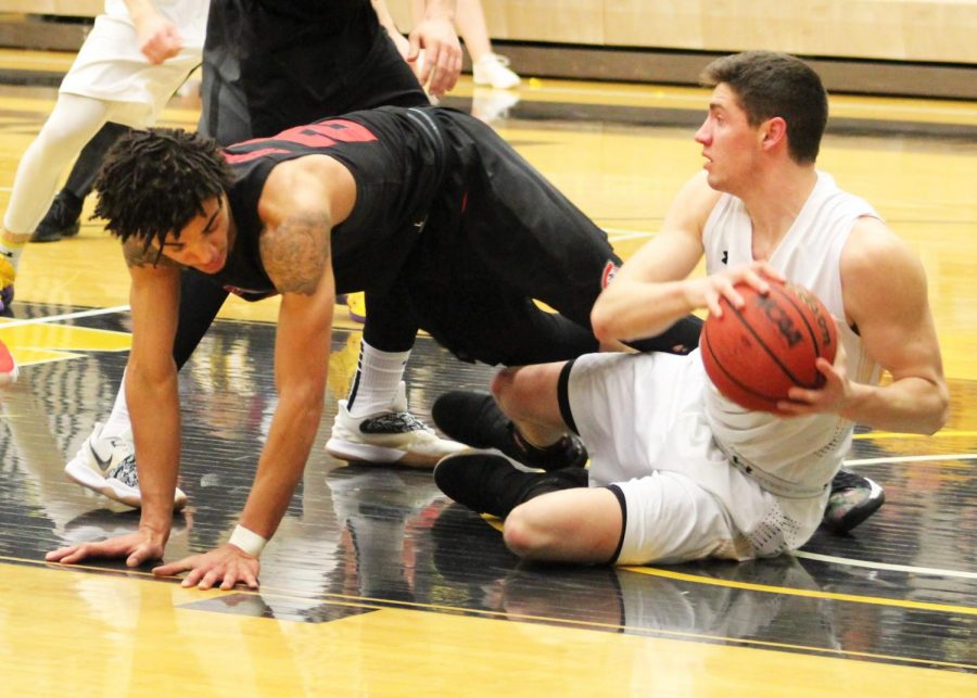 Sophomore Ben Detlinger scrambles on the ground for a loose ball against Saint Cloud opponent Friday night. 