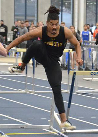 Robert Sullivan races over a hurdle while competing in the heptathlon, an event that combines seven different events including the 60 meter dash, 60 meter hurdles, 1,000 meter run, high jump, long jump, shot put, and pole vault. 