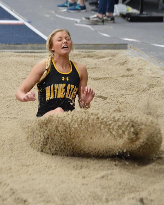 Riana Noelle jumps into the pit during the long jump.