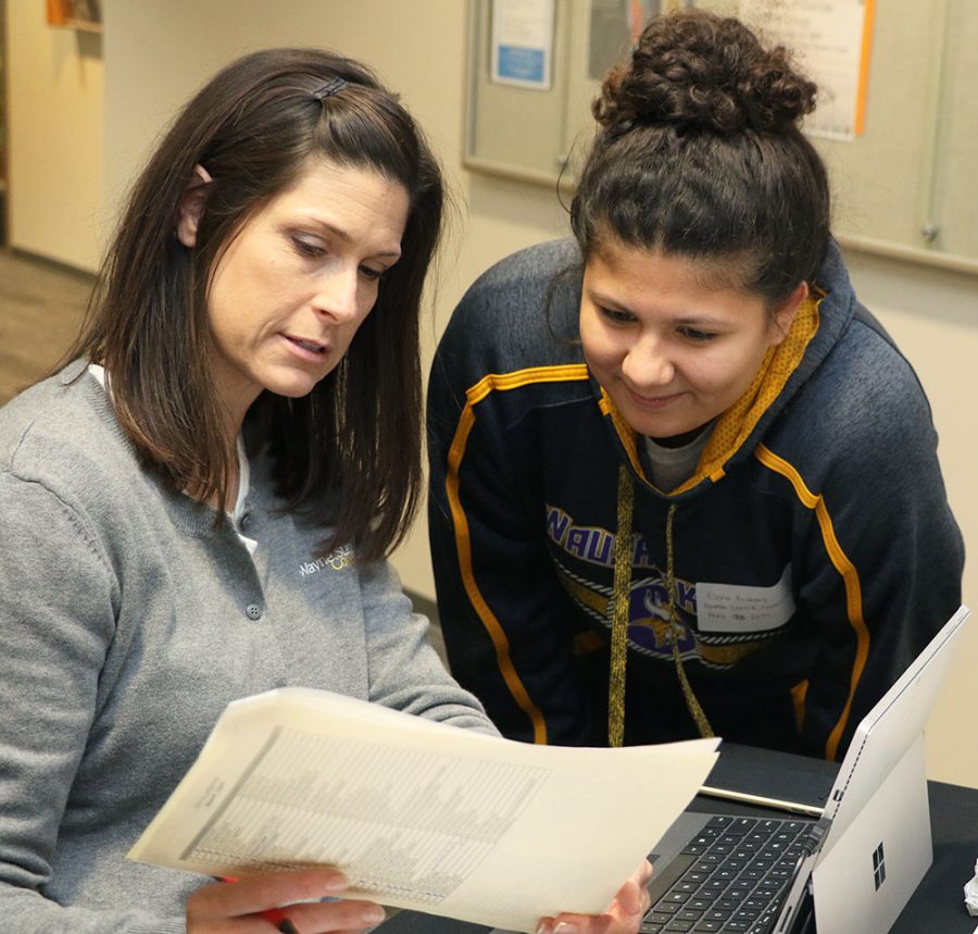 Wayne State College student Elena Rosberg (right) consults with Jessie Piper (left) at the Career Fair