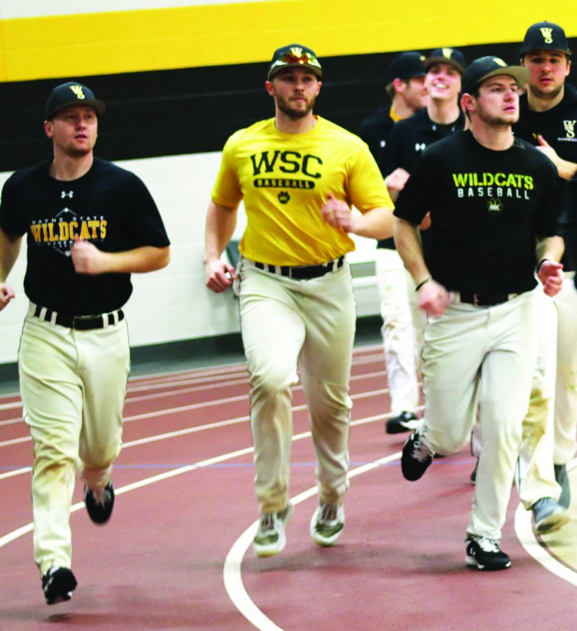WSC baseball players participate in warmup laps at the beginning of practice.