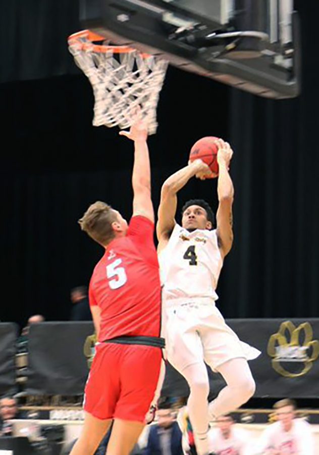 Senior AlTavius Jackson goes up for a shot contested by an MSU-Moorhead opponent.