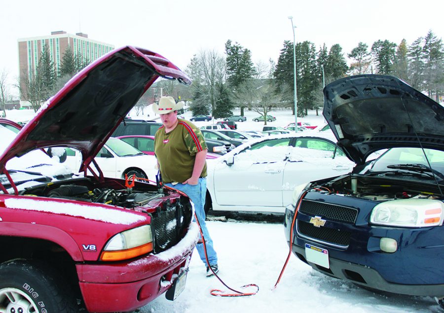 Tristan Vick helping WSC student Jade Sandoval (not pictured) jump-start car.