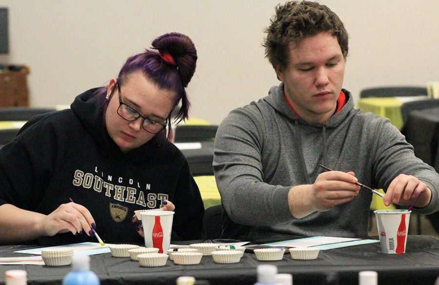Skylar Glynn and Tyler Spicer practice their painting skills in preparation for the He(art) therapy sessions.