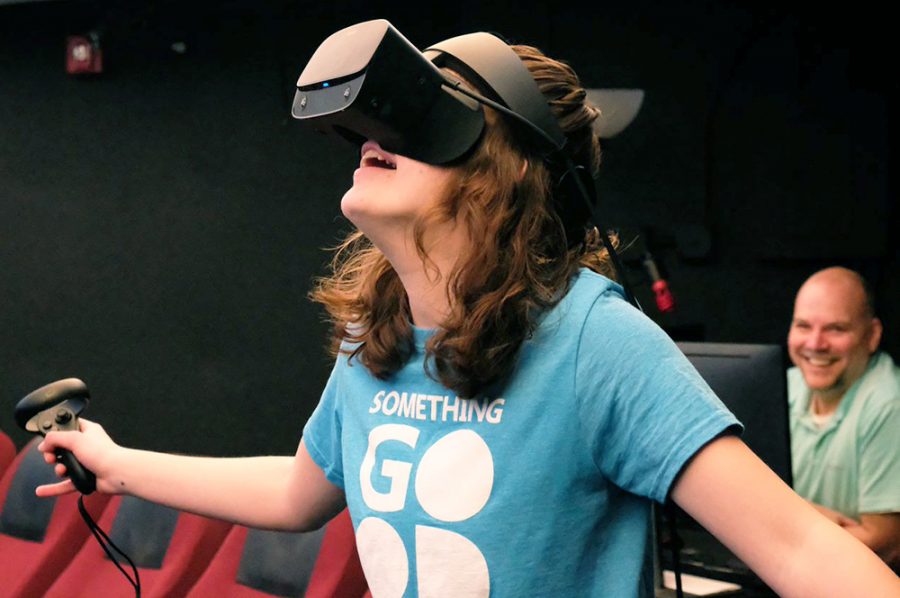 Ashley Ternus tries out the Oculus Rift VR system, while Dr. Todd Young observes from a computer.