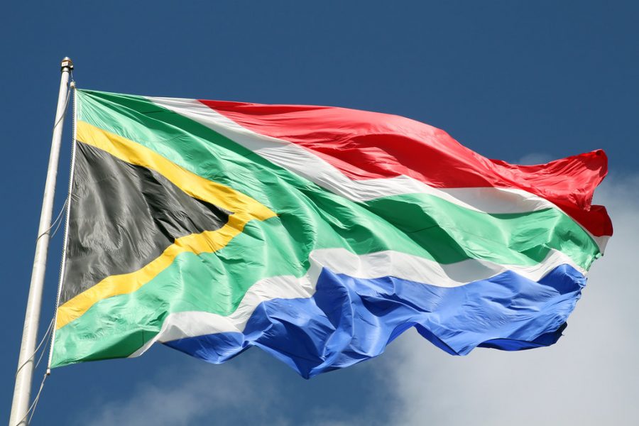 South African flag, Port Elizabeth, Eastern Cape, South Africa by flowcomm is licensed with CC BY 2.0. To view a copy of this license, visit https://creativecommons.org/licenses/by/2.0/ Photo by Creative Commons