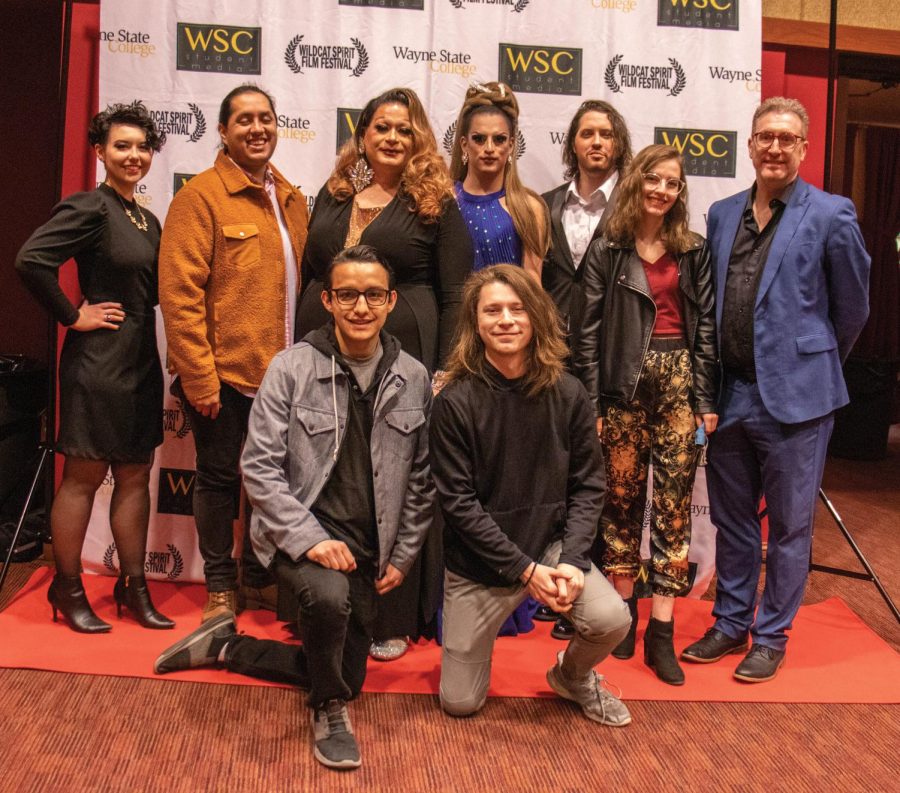 Cast and crew members of The Queen of Pandoras box pose on the red carpet before the premiere of the film.