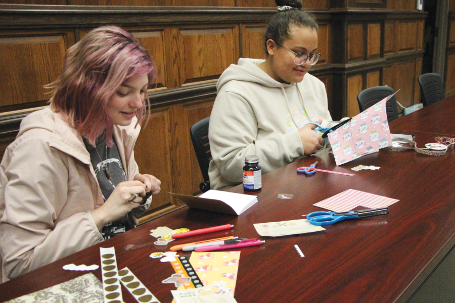 Emily DeTour and Machara Jusinjo cut and glue their scrapbooks together at SAB’s Scrapbooking event on February 21st. 