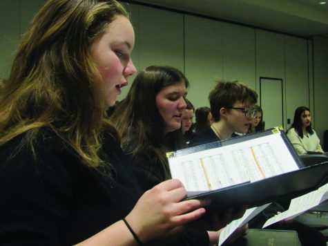 Treble Honor Chior members Akara Hall, left, Addysen, middle and Oliver, right, sing in the alto part during sectional time.