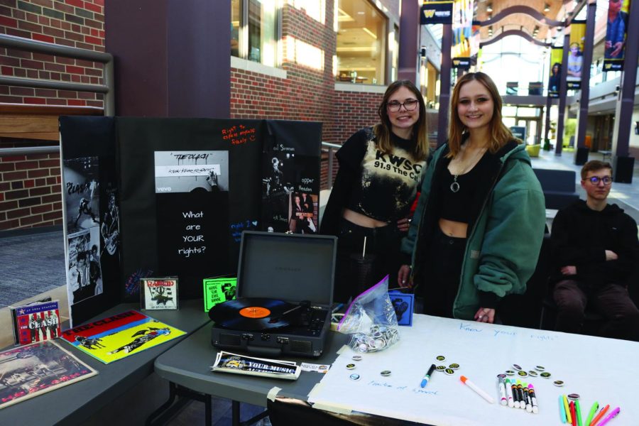 Jasmine Snyder and Hailey Walsh stand next to KWSCs tabling event celebrating International Clash Day on Feb. 7.
