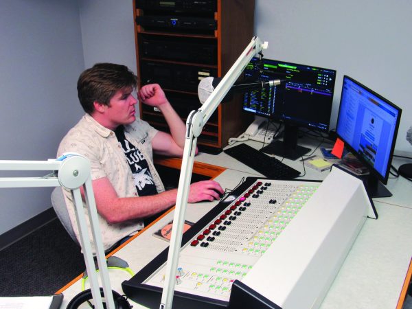 KWSC advisor Sean Ahern works on deciding what music to play on the school’s 
radio station.