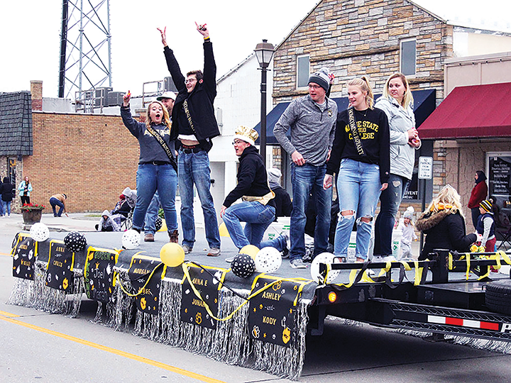 Members of the Fall 2019 Homecoming Court ride along Main Street during the homecoming parade. Photo courtesy of Stater Staff Fall 2019.