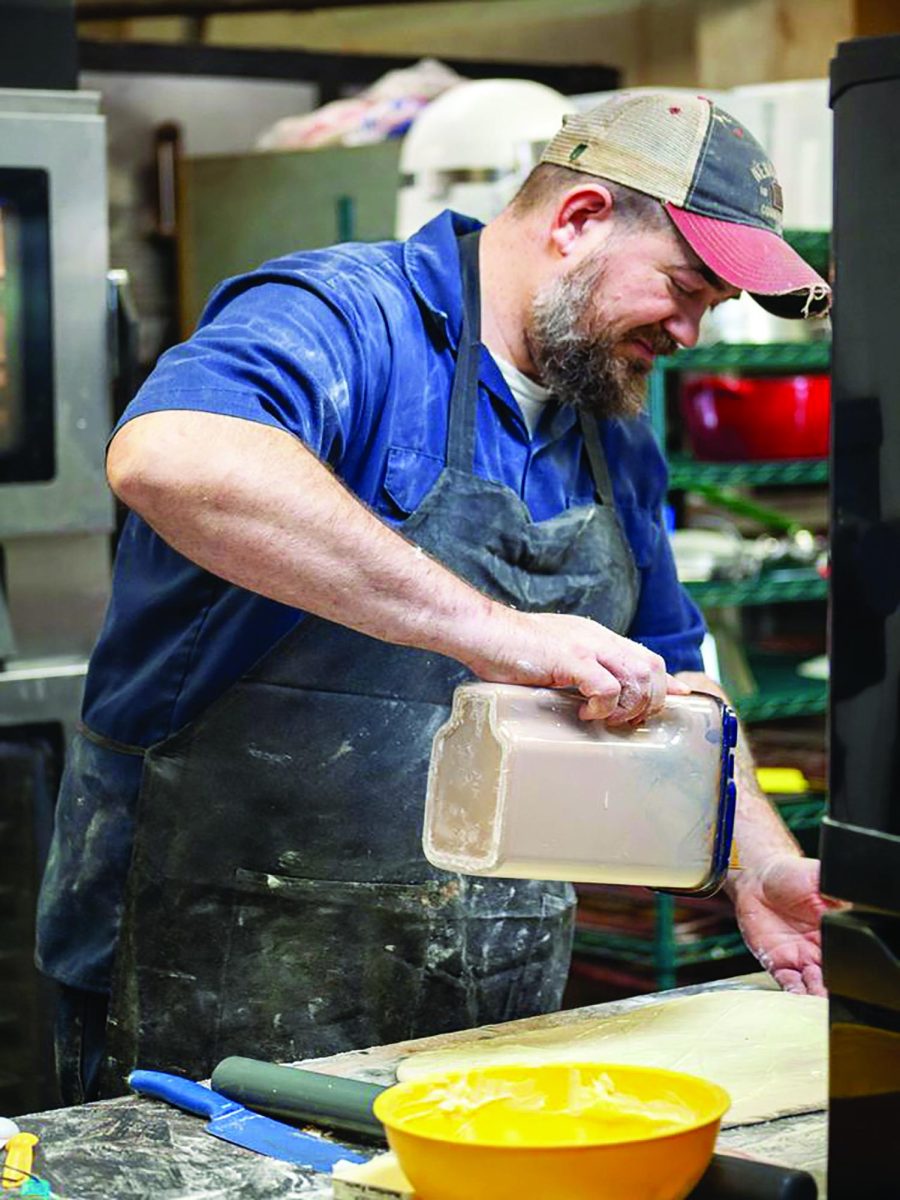 HIS Baking Co. owner Chris Beach makes baked goods in the kitchen. Photo by Taylor Sloger.