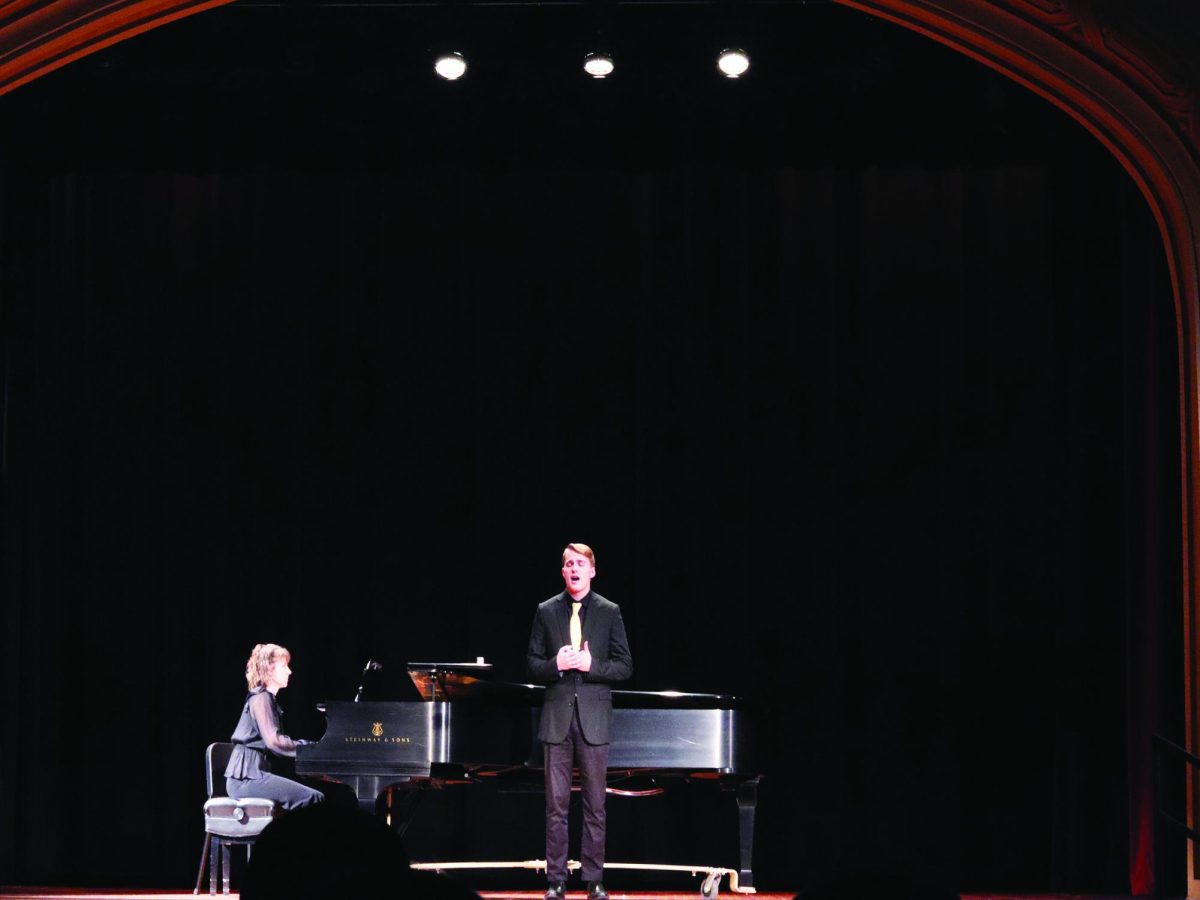 WSC senior Logan Hellerich, right, sings one of the pieces for his recital while being accompanied by WSC staff accompanist Shelly Armstrong (left). Photo by Cassie Schlautman.