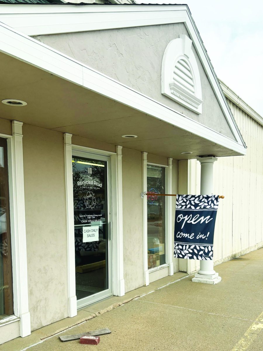 A poster advertising the Recycled Read event hangs on the door of the Wayne Public Library. Photo by Cassie Schlautman. 