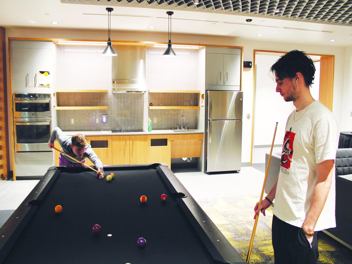 WSC students Brody Lucas, left, and Kylian James, right, play pool in the newly opened Stearns Residence Hall. 