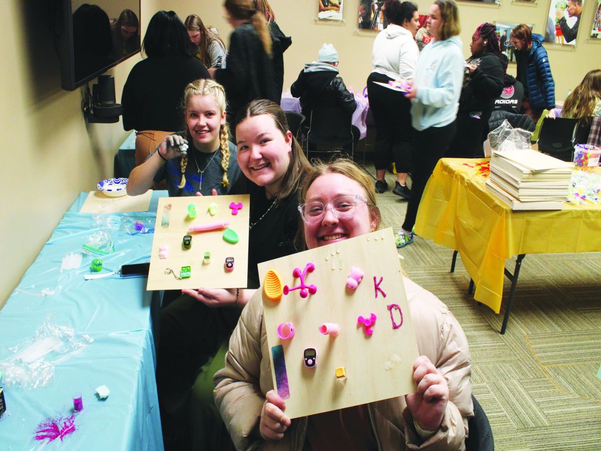 WSC students Kortney Rees, left, Dani Dowling, middle, and Mackenzie Divis, right, pose with fidget boards from the CatPAC's 'Let's Get Handsy' event.
