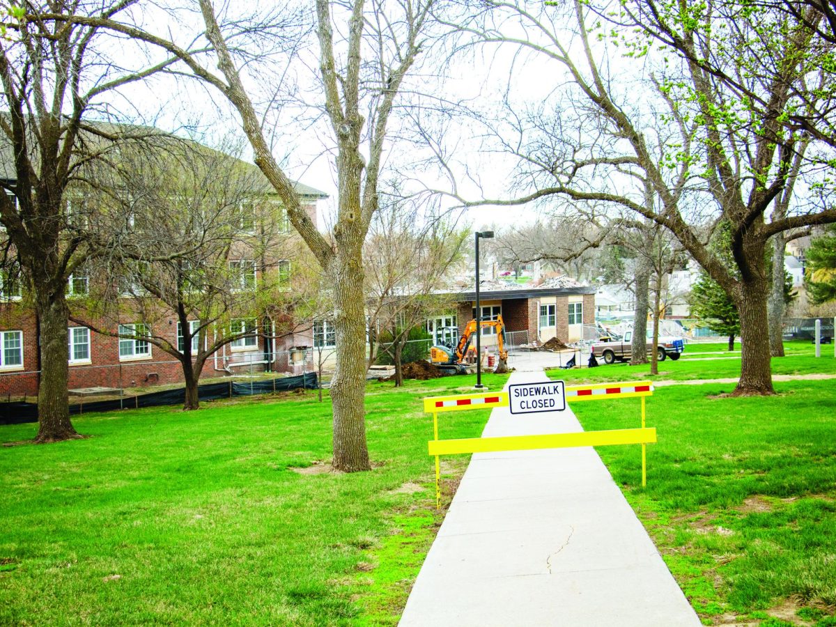 A closed sign blocks the sidewalk leading to Berry Hall, which is undergoing demolition. 