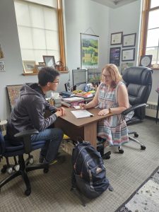 Stephanie Marcellus, an advisor on campus, talking about classes with a student.