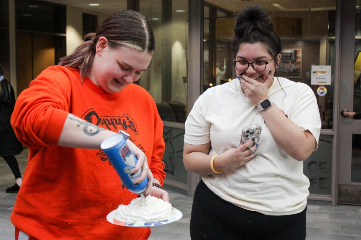 A Wayne State College student pies Rachel Kunz, a WSC criminal justice professor, at the Pie-A-Professor fundraiser in the Kanter Student Center atrium on Wednesday, April 15.